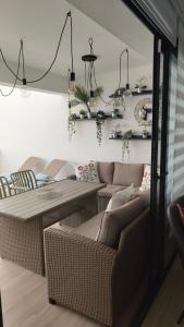 a living room with wicker chairs and a table at Casa Fuerte y Levamt in Villaverde