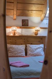 a bedroom with a bed with two lights on it at Penzion Vinicky dvůr in Kaplice