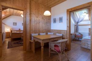 a dining room with a wooden table and chairs at Penzion Vinicky dvůr in Kaplice