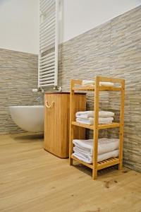 a bathroom with a towel rack and a bath tub at RG MAISON - Room 35 in Morino +55 photos