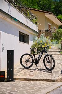a bike parked next to a building with flowers on it at RG MAISON - Room 35 in Morino