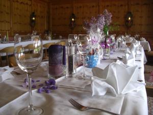 a table with wine glasses and napkins on it at Ferienhotel Barmsee in Krün +38 photos