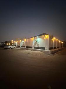 a building with lights in a parking lot at night at شاليهات أفق in Jeddah