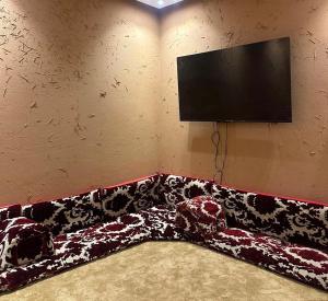 a couch in a room with a flat screen tv at شاليهات أفق in Jeddah