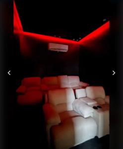 a room with a bed and a couch and red lights at شاليهات أفق in Jeddah +7 photos