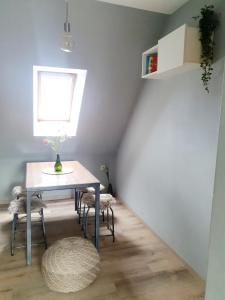 a table and chairs in a room with a window at Ferienwohnung Pension Zwethau in Beilrode