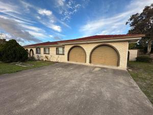 a house with two garage doors in a driveway at Casa Sarina in Stanthorpe