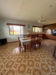 a dining room with a table and chairs on a tile floor at Casa Sarina in Stanthorpe