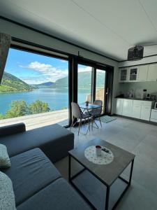 a living room with a couch and a table with a view at Olden Apartment with Panorama view in Olden