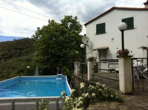 eine Villa mit einem Pool vor einem Haus in der Unterkunft Dolcevia in Levanto