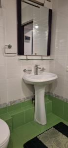 a bathroom with a white sink and a mirror at Иссык-Куль in Tossor