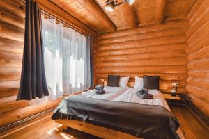 a bedroom with a bed in a log cabin at Holzhaus in Sadu +70 photos
