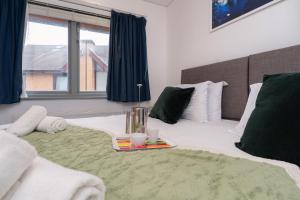 a bedroom with a bed with a tray on it at Open Mind Property - Spacious 2BR Flat City Views in Portsmouth +13 photos