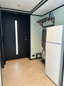 a kitchen with a black door and a refrigerator at Olden Apartment with Panorama view in Olden