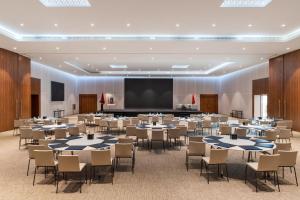 a conference room with tables and chairs and a projection screen at The View Bouznika in Bouznika +229 photos