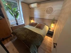 a bedroom with a bed and a window at Capstay Dinant in Dinant
