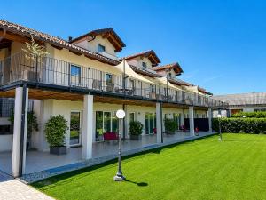 a large building with a lawn in front of it at CASCINA SANT'ANTONIO in Alba