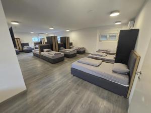 a room with several beds and couches in it at Hostel P16 in Zagreb