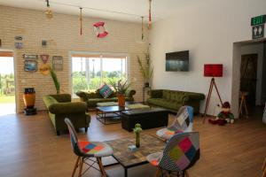 a living room with green couches and chairs at Casa Biba in Utique