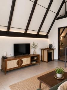 a living room with a flat screen tv at DZION Resort Coorg in Gonikoppal