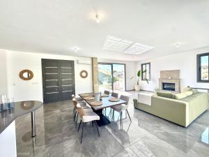 a living room with a couch and a table at Villa Tuludis in Drousha