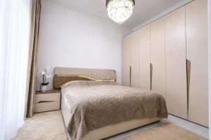 a bedroom with a bed and a large closet at Grey House in Bucharest +34 photos