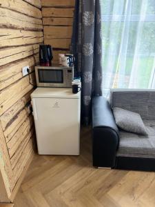 a living room with a microwave and a couch at ZenTen Apartment in Elva +2 photos