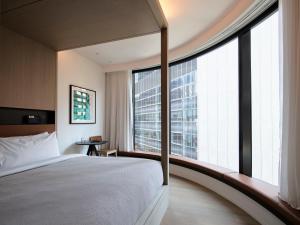 a hotel room with a bed and a large window at Little National Hotel Adelaide in Adelaide