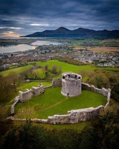 an old castle on top of a grassy field at Murlough View in Dundrum
