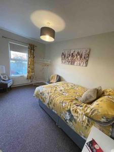 a bedroom with a large bed and a window at Murlough View in Dundrum