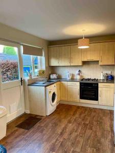 a kitchen with a washer and a dishwasher at Murlough View in Dundrum
