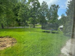a yard with a trampoline in the grass at ZenTen Apartment in Elva