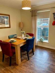 a dining room with a wooden table and chairs at Murlough View in Dundrum +15 photos