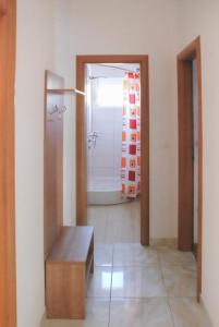 a bathroom with a bench and a shower and a tub at Danica Roof in Tučepi