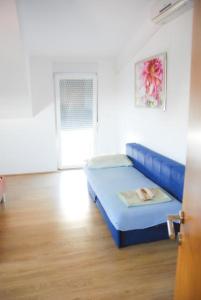 a bedroom with a blue bed in a room at Danica Roof in Tučepi