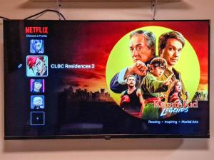 a tv screen with a movie on the wall at CLBC Residences - 2B in Ibaba