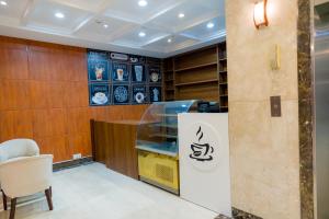 a store with a sign on the wall next to a chair at فندق عصفور 03 in Mecca