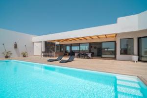 a villa with a swimming pool and a house at Villa Karuna by Aura Collection in Villaverde +39 photos