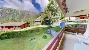 an outdoor balcony with a view of a house at Haus Belstar A in Naters