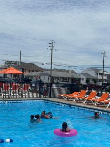 a group of people swimming in a swimming pool at Sea Chest Motel in Wildwood Crest +8 photos