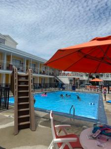 a pool at a resort with people swimming at Sea Chest Motel in Wildwood Crest