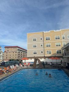 a swimming pool with a slide in a hotel at Sea Chest Motel in Wildwood Crest