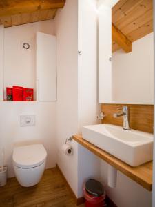a bathroom with a white sink and a toilet at Chalet Safran in Grächen +70 photos