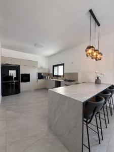 a large kitchen with a large island in the middle at פנטהאוז Siesta in Eilat