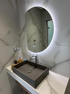 a bathroom with a sink and a mirror at Aiolis Studios in Porto Koufo +87 photos
