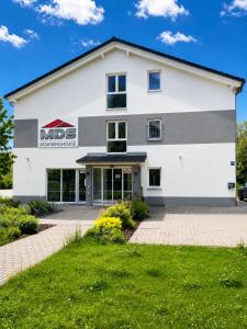 a white building with a nds sign on it at Boardinghouse MDS in Aschheim