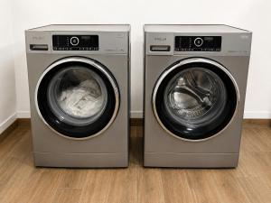 two washing machines sitting next to each other at Boardinghouse MDS in Aschheim
