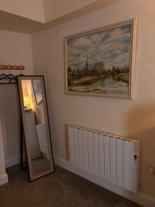 a room with a mirror and a painting on the wall at Fahertys bar rooms in Oughterard