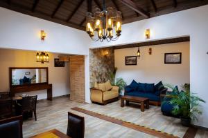 a living room with a blue couch and a chair at Villa D55 - A Private Villa with Character & Comfort in Kandy
