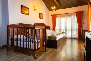 a bedroom with two cribs in a room at Villa D55 - A Private Villa with Character & Comfort in Kandy +25 photos